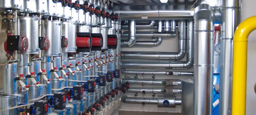 A modern building with a room full of pipes and valves dedicated to municipal pipe cleaning and water collection.